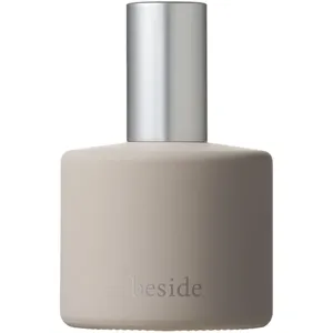 Osaji beside perfume bottle